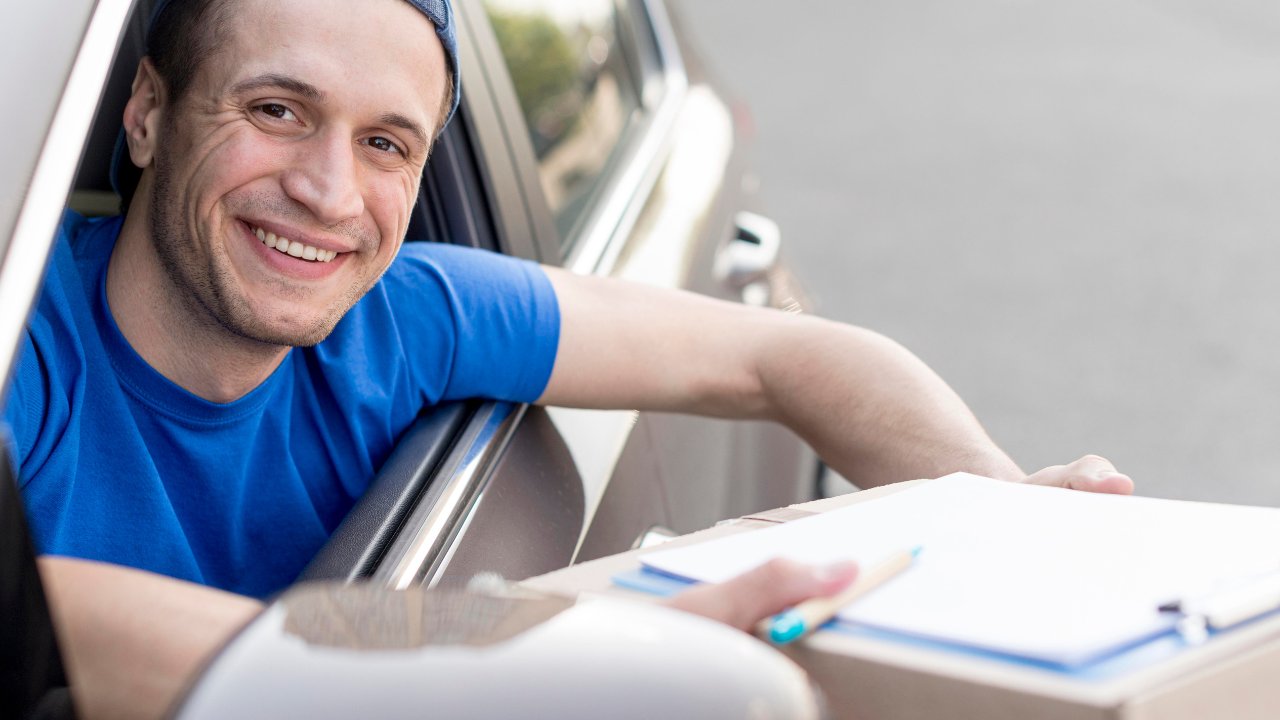 Happy driver confirming delivery details during a cross country move in Canada - Burly Boyz Moving and Storage