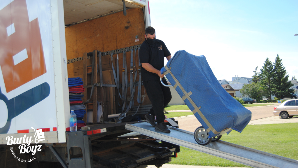 Burly Boyz mover unloading furniture for a local move.